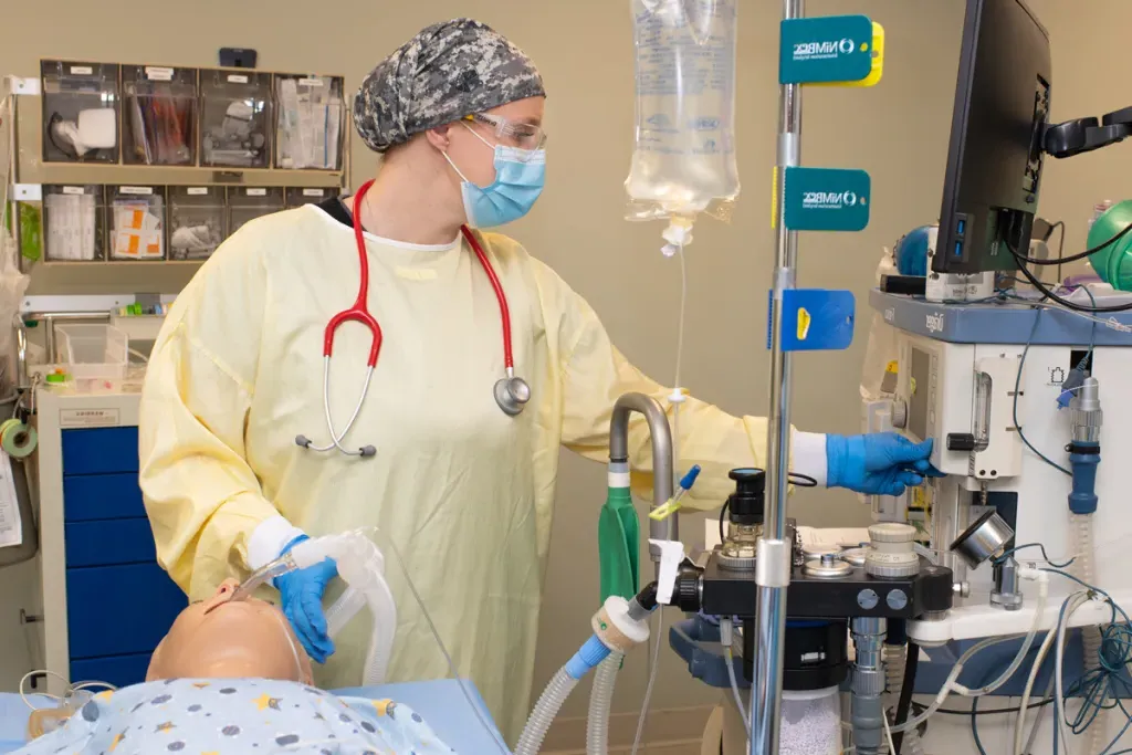 A U N E student practices giving a patient simulator anesthesia