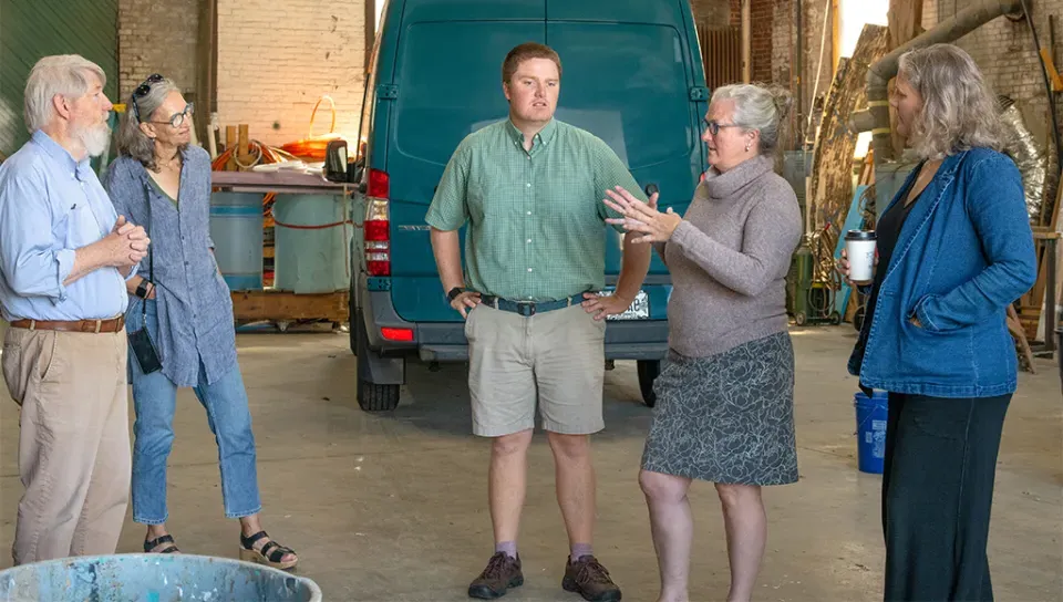 Delilah Poupore, Heart of Biddeford; Alethea Cariddi, UNE; Will Kotchtitzky, UNE; and Michele Polacsek, UNE speak to a community member inside a building in Biddeford.